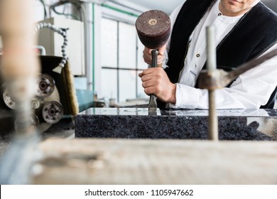 Stone Mason Working On Tombstone In His Workshop