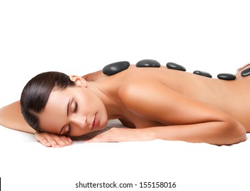 Stone Massage. Beautiful Woman Getting Spa Hot Stones Massage in Spa Salon.
