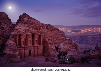 Stone Monastery in rock, Petra in Jordan. Red rock landcape. Petra historical sight - Ad Deir Monastery with full moon during the night. Evening light in nature. Travel in Jordan, Arabia in Asia. 