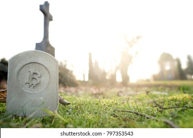 Stone Monument/tombstone With Bitcoin Symbol Standing In Green Grass On Cementery In Front Of Stone Cross - Wide Angle View - Sunny Blurred Background With Space For Text - Economic/financial Concept