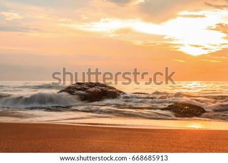 Stone in the ocean at sunset, Kalutara, Sri Lanka