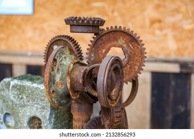 A Stone In The Park Is Inlaid With A Pile Of Rusty Gear Sculptures