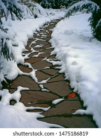 Stone Path After The First Snowfall In The Garden