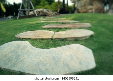 Stone path in green grass