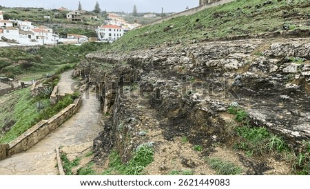 Stone path winding through lush green hills, scenic hiking trail, serene countryside landscape, perfect for outdoor adventures and family picnics 
