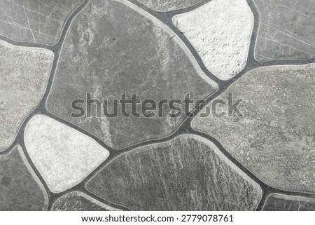 ​Grey stone pattern ceramic floor tile texture background with dark grout lines.