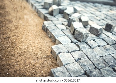 Stone Pavement, Construction Worker Laying Cobblestone Rocks On Sand