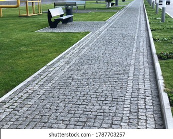 Stone pavement in perspective. Stone pavement texture. Granite cobblestoned pavement background. Abstract background of a cobblestone pavement 