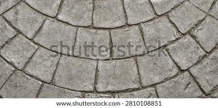 Stone pavement texture.
Fan patterned background with grey textured natural stone or cast concrete floor surface.