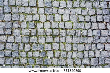 Stone pavement texture. Granite cobblestoned pavement background. Abstract background of old cobblestone pavement close-up. Seamless texture. Prague