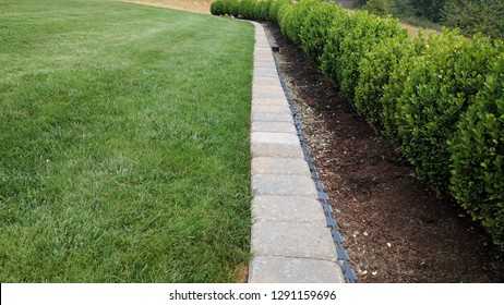 Stone Paver Mowing Strip On Edge Of Lawn