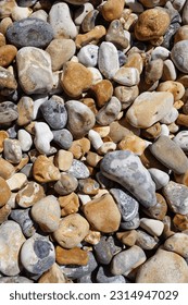 Stone and pebble background. various color and sized pebbles on stony beach  - Shutterstock ID 2314947029