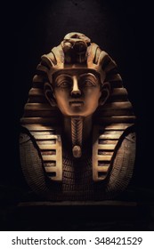 Stone pharaoh tutankhamen mask on dark background