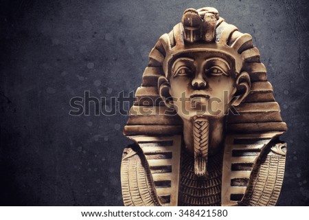 Stone pharaoh tutankhamen mask on dark background