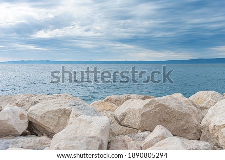 Stone pier on the sea coast in the evening.