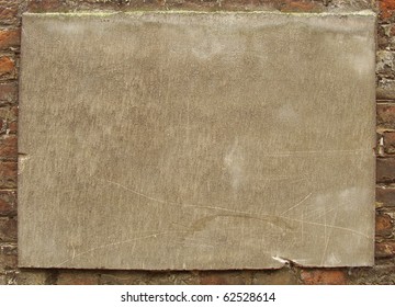 Stone Plaque On An Old  Worn Brick Wall