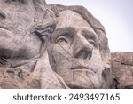 The stone profile of Thomas Jefferson at Mount Rushmore looks to the horizon