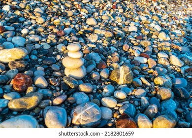 Stone pyramid. Pebbles balance pile, harmony zen stones, balance stack, sea pebble pyramid on shoreline, relaxation and peace concept