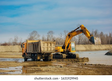 Stone Quarry In Russia, Loading A Stone With An Dredge, Loading Stone From A River Bed To Produce Crushed Stone, Digger Loads Stones Into A Truck, Dredge Digs A Ditch