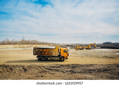 Stone Quarry In Russia, Loading A Stone With An Dredge, Loading Stone From A River Bed To Produce Crushed Stone, Digger Loads Stones Into A Truck, Dredge Digs A Ditch