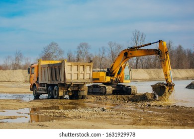 Stone Quarry In Russia, Loading A Stone With An Dredge, Loading Stone From A River Bed To Produce Crushed Stone, Digger Loads Stones Into A Truck, Dredge Digs A Ditch