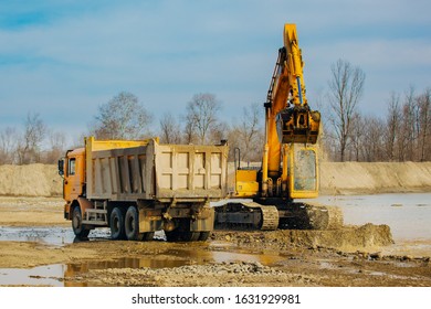 Stone Quarry In Russia, Loading A Stone With An Dredge, Loading Stone From A River Bed To Produce Crushed Stone, Digger Loads Stones Into A Truck, Dredge Digs A Ditch