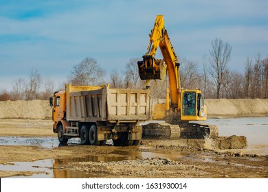 Stone Quarry In Russia, Loading A Stone With An Dredge, Loading Stone From A River Bed To Produce Crushed Stone, Digger Loads Stones Into A Truck, Dredge Digs A Ditch