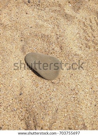 Similar – Beautiful hand holding a stone, on a beach sand background.