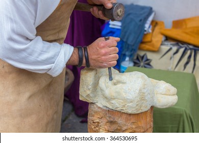 Stone Sculptor Working With His Tools