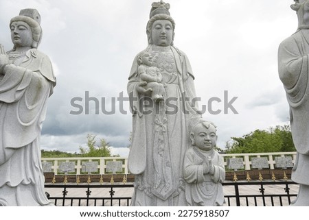 Stone sculpture of mother and children