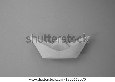 Stone sculpture of a origami boat
