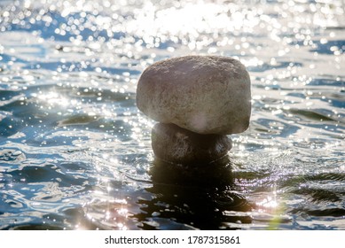 A Stone Sculpture Stands In Seawater