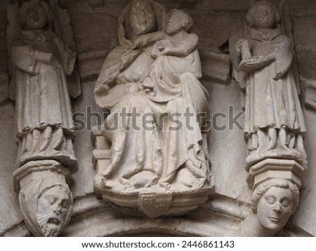 stone sculptures of the Virgin Mary with the child in her arms guarded by two angels, portal of the parish church of Conesa, Tarragona, Spain, Europe