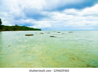 Stone Sea Rock On The Beach Ocean Blue Green Water During Sunset Sunrise With Cloudy Blue Sky In The Tropical Pacific Asian Island For Peaceful Zen Family Couple Holiday Retreat