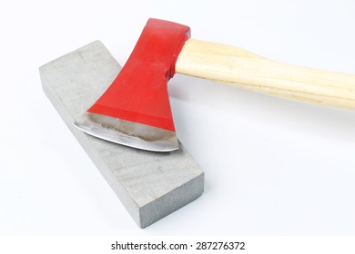 Stone Sharpening An Ax On A White Background.