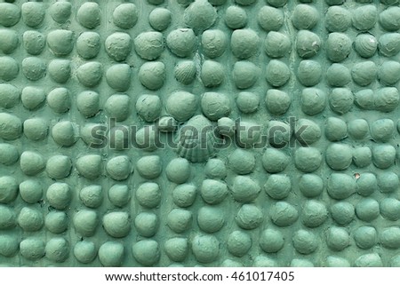 Stone with shell on the wall painded in green, the background texture, pattern