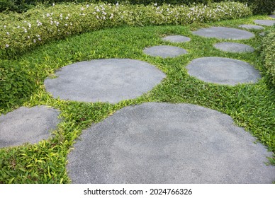 Stone slab with grass pathway in the garden. - Powered by Shutterstock