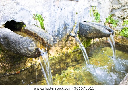 Stone source of drinking water comes from a rock wall