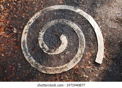 Stone Spiral As A Trail Marker On A Wet Forest Hiking Trail