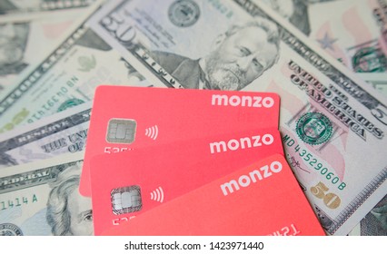 Stone, Staffordshire / United Kingdom - June 14, 2019: Photo Of Three Monzo Bank Cards On The Real Dollar Banknote Background. Virtual Bank Monzo Emerging On US Market With Their Multicurrency Account