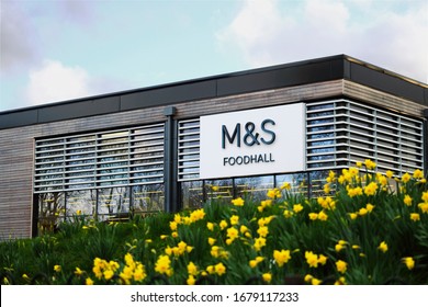 Stone, Staffordshire / United Kingdom - March 21 2019: M&S Foodhall Supermarket. Marks & Spencer Shop Front Surrounded By Flowers. 