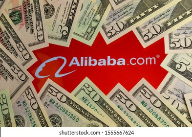 Stone, Staffordshire  United Kingdom - November 10 2019: Alibaba Logo On A Screen Surrounded By Dollar Banknotes. Conceptual Photo For The News About Record Breaking Revenues Of Alibaba.