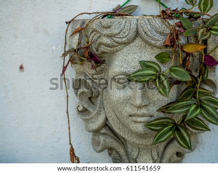 Stone statue with leaves