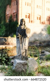 Stone statue with sword and shield.