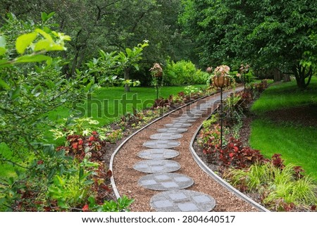 Stone stepping path meandering through a vibrant, colorful dOW gardens, Michigan