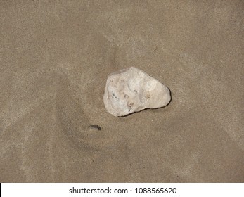 Stone surrounded by sand
