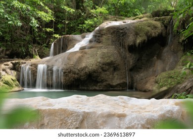 Stone table top podium floor in outdoor waterfall green tropical forest nature background.Natural water product present placement pedestal counter display, spring summer jungle paradise concept. - Powered by Shutterstock