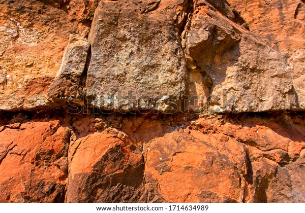 Stone texture and background.
Rock texture. The Enormous face Aging and Divided by Huge Cracks
and Layer. Thick, Rough Stone Texture Or Mountain Rock,
Background.