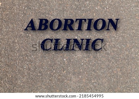 stone texture background with text abortion clinic