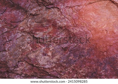 Stone texture background with unique pattern. Pink rock texture. Rock surface abstract background. Natural stone background. Purple rough stone floor. Grunge and rust rock texture.